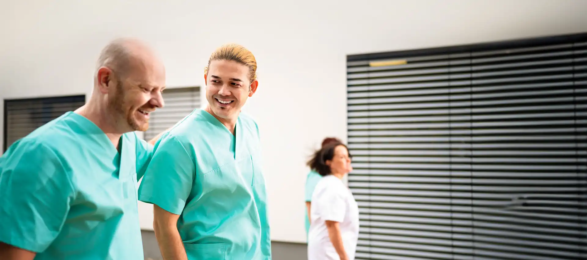 Zwei Krankenpfleger mit Arbeitskleidung